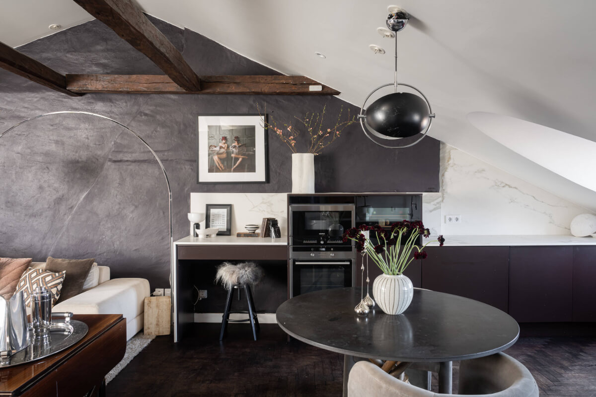A Stylish Black and White Penthouse Apartment in Stockholm 7 kitchen black wall wooden beams marble countertop round table