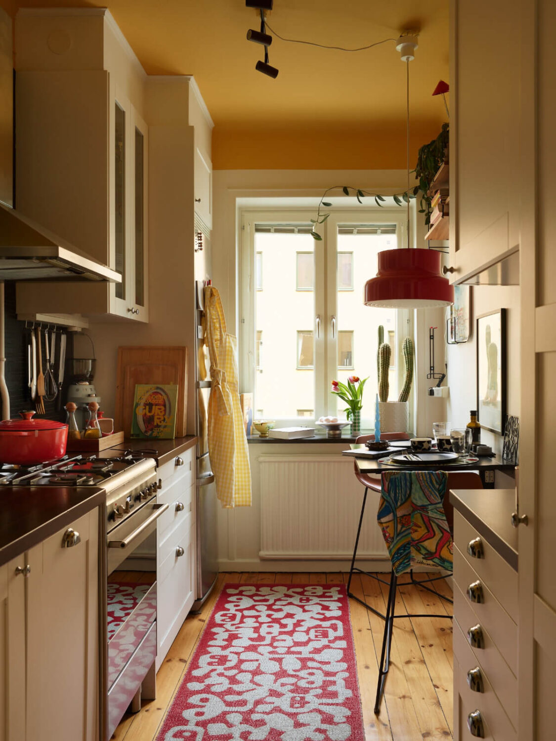 Best of 2025: Studio & Loft Apartments 11 kitchen bright yellow ceiling small bar table
