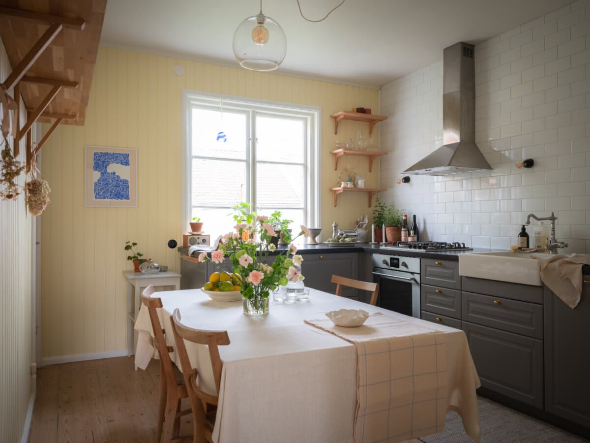 A Soft Color Palette and a Charming Kitchen in a Swedish Apartment 1 kitchen butler yellow tongue and groove paneling