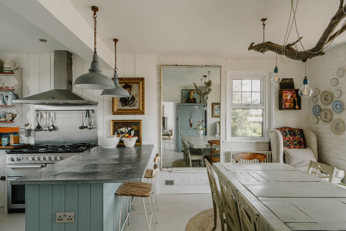 A Bright English Seaside Home Owned by Artists 7 kitchen dining space antique art mirror