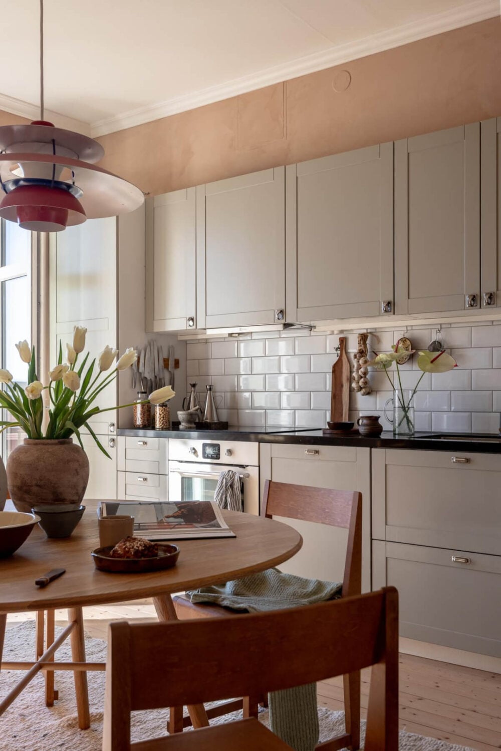 A Natural Color Palette, Period Features, & Grand Rooms in a Swedish Home 28 kitchen gray cabinet doors round dining table