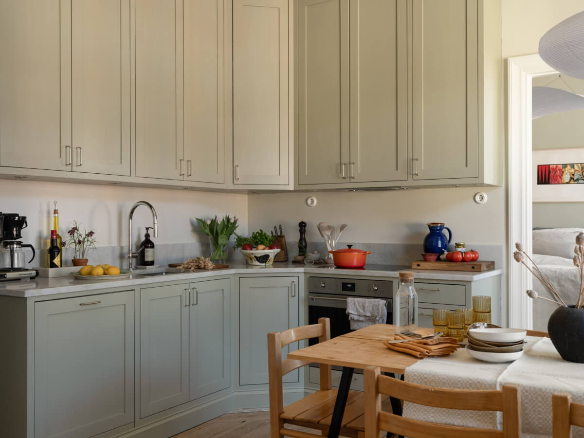 Turn-of-the-Century Charm and Site-Built Storage in a Stockholm Apartment 9 kitchen light gray-green cabinets