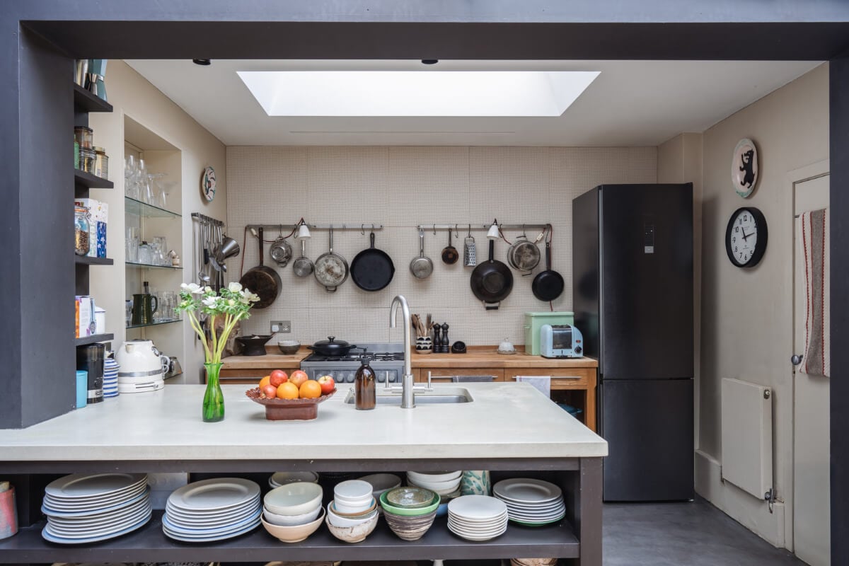 An Edwardian House with Muted Tones, Natural Materials, and a Landscaped Garden 9 kitchen open storage skylight