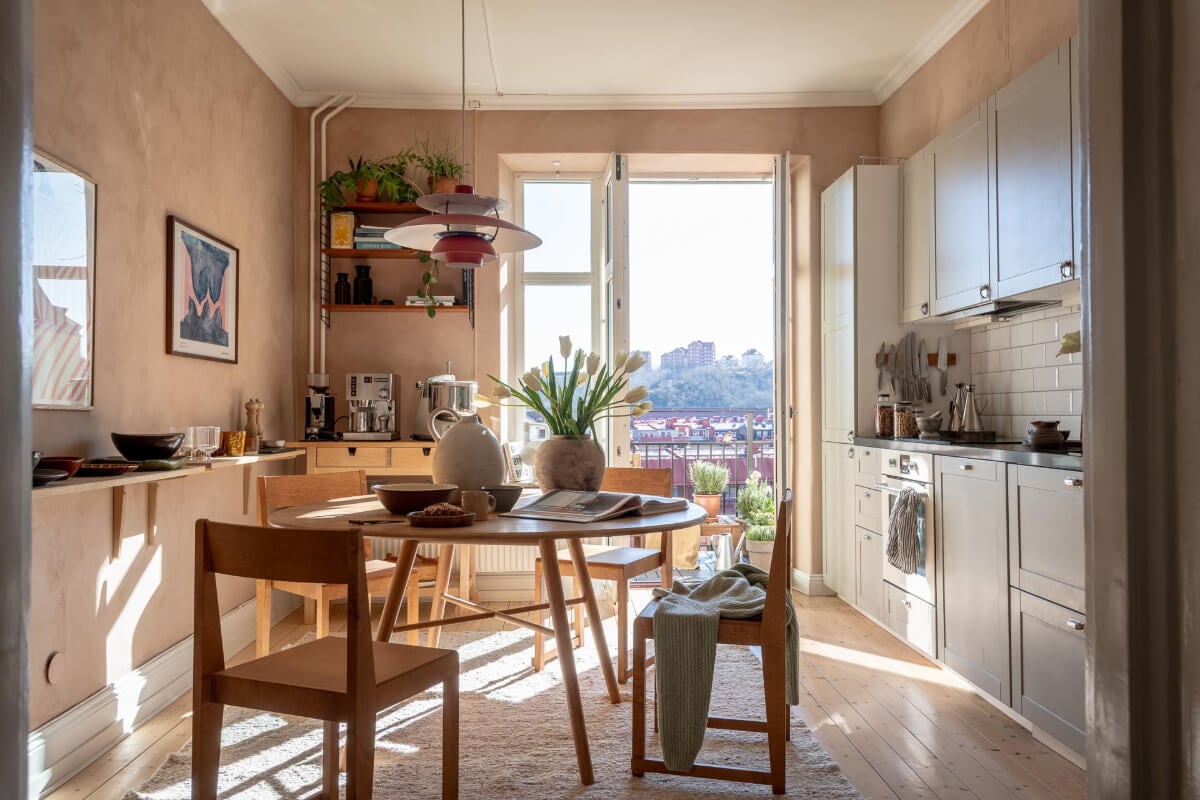 A Natural Color Palette, Period Features, & Grand Rooms in a Swedish Home 19 kitchen plaster walls round dining table shelf