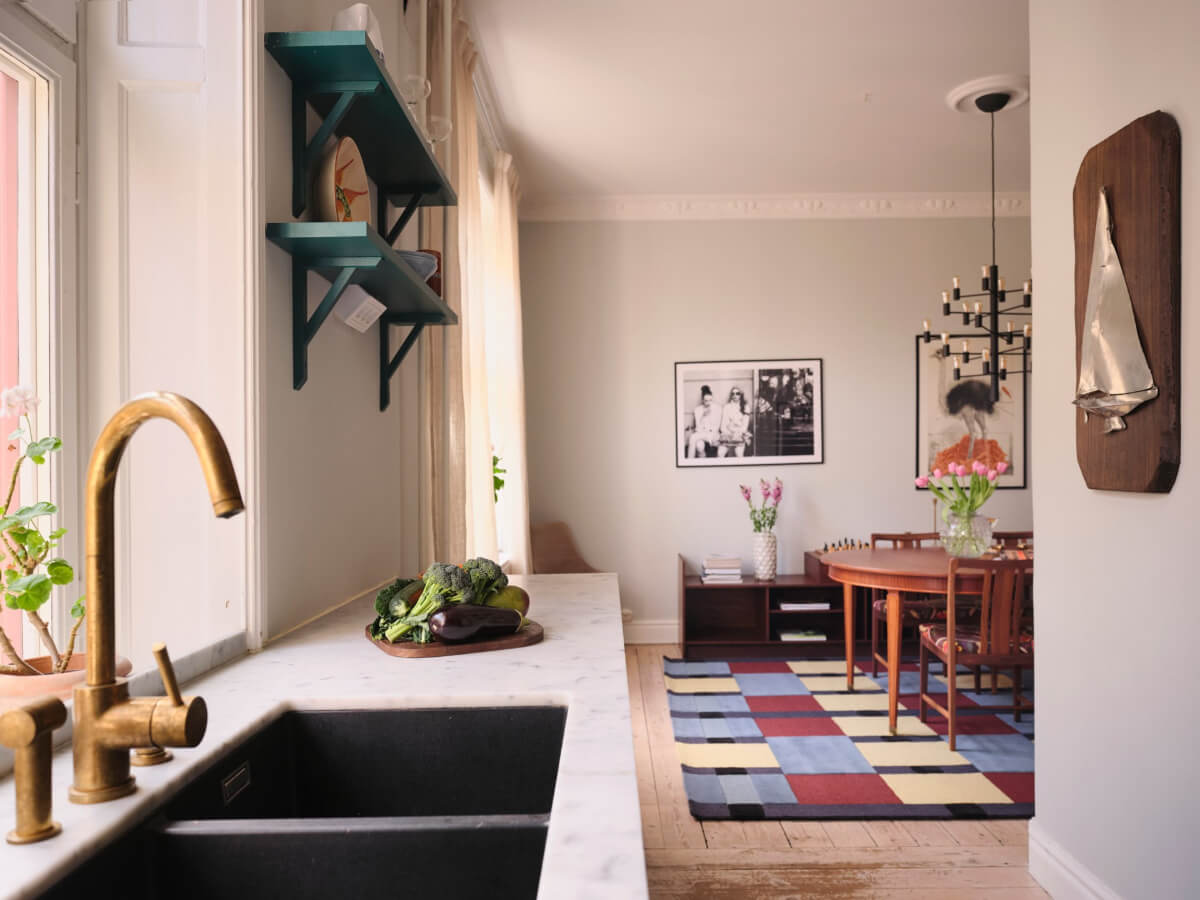 A Spacious Turn-of-the-Century Apartment with Nice Color Accents 9 kitchen view into dining room