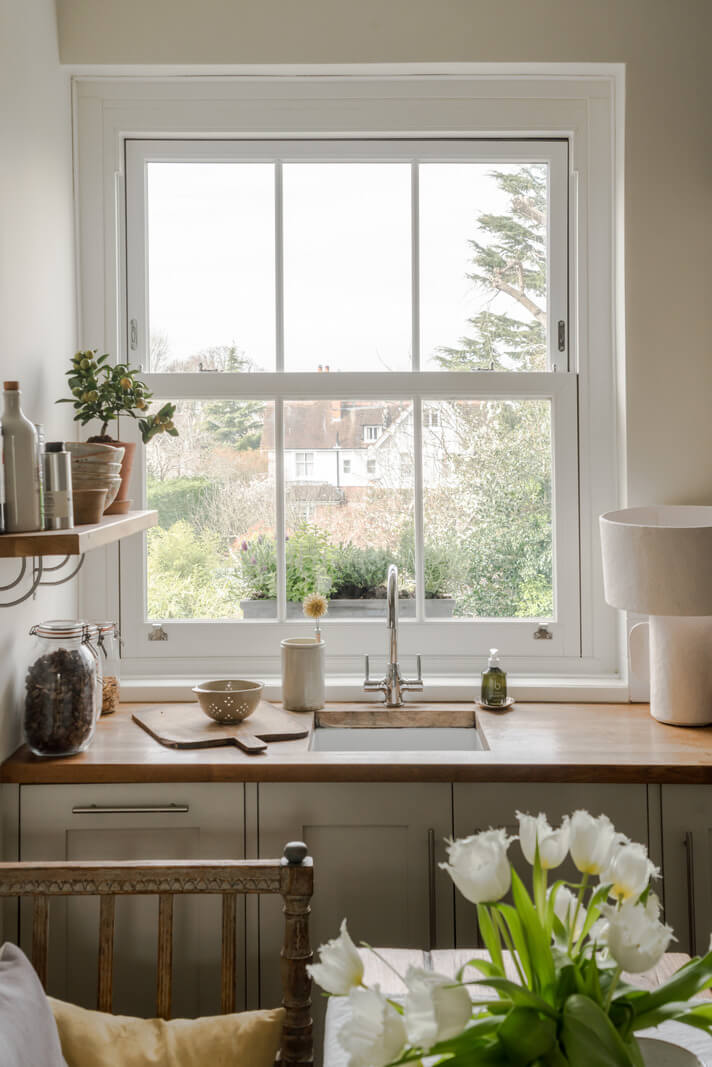 A Serene Color Palette and Arched Windows in a Small English Apartment 7 kitchen window