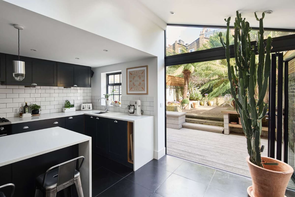 Light and Dark in a Spacious Victorian Townhouse in London 15 kitchen with glass doors to garden