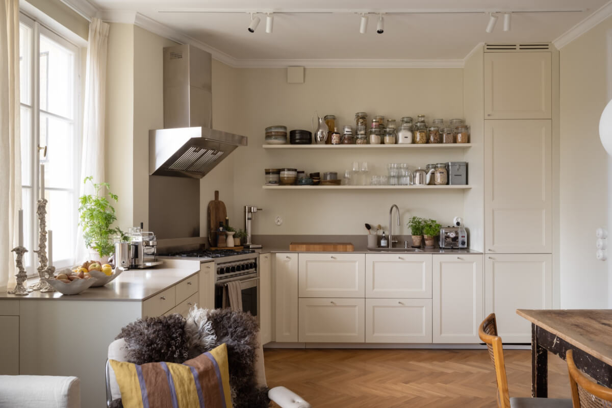 A Beige Color Palette and Built-in Bookshelves in a 1920s Apartment 8 kitchen with open shelves