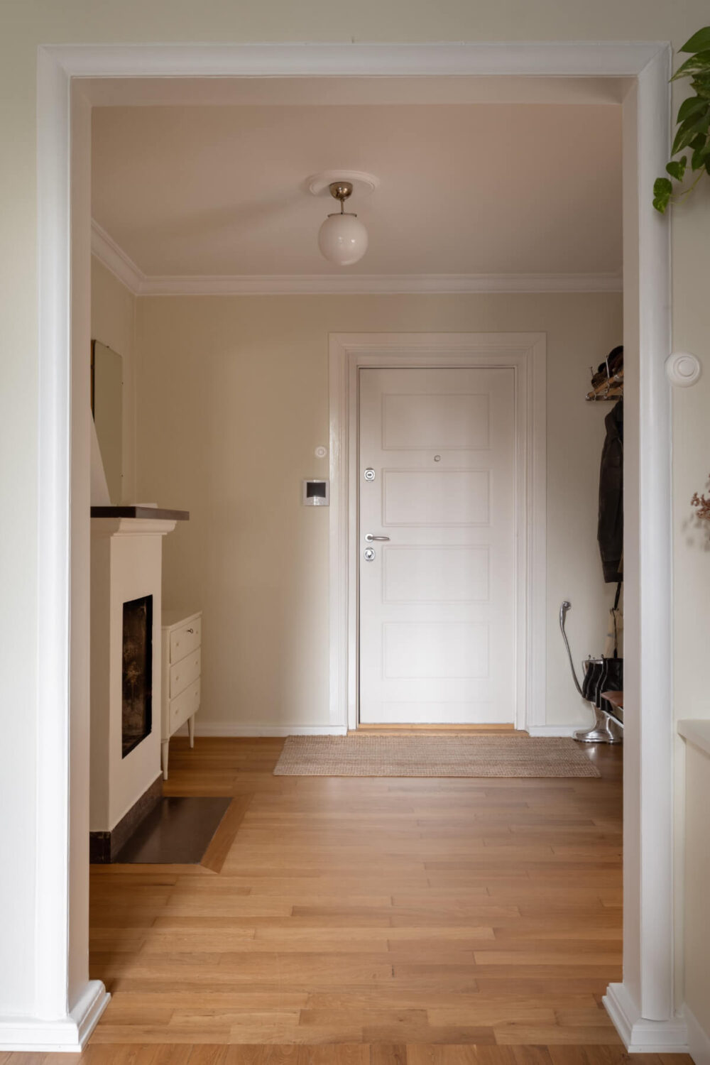 A Beige Color Palette and Built-in Bookshelves in a 1920s Apartment 17 large hall with fireplace