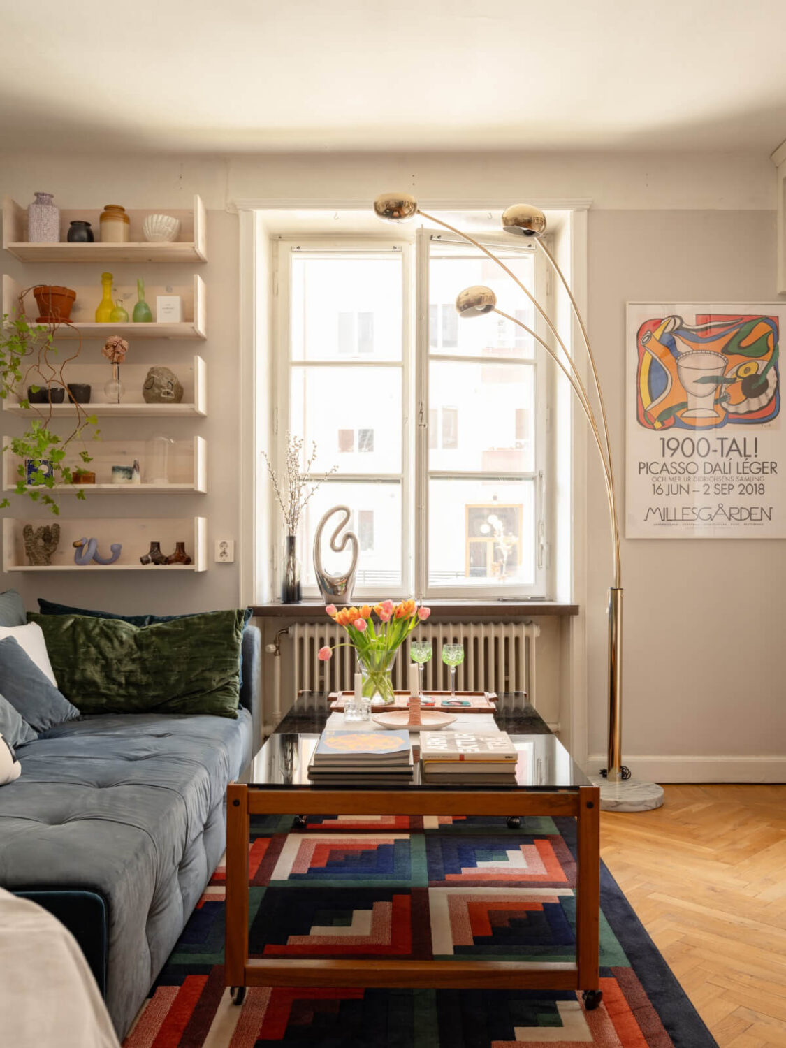 A Small, Cozy Apartment with Built-in Storage and Bookshelves 2 large window small living room colorful rug