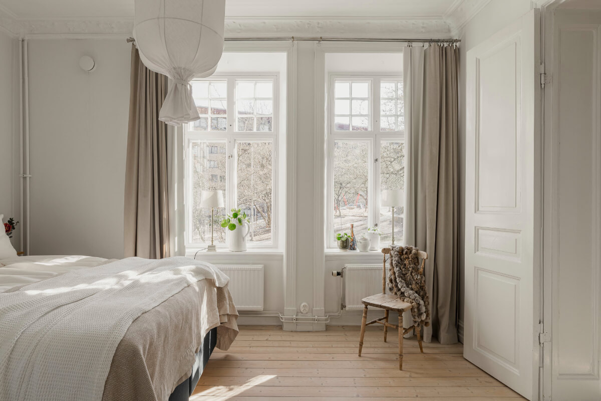 A Bright Swedish Apartment with Period Features and a Green Kitchen 18 large windows light bedroom