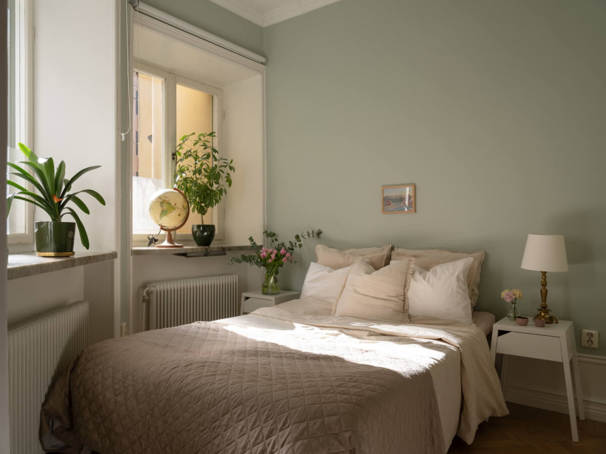A Small Apartment with Green Color Accents and a Cozy Patio Terrace 12 light green bedroom