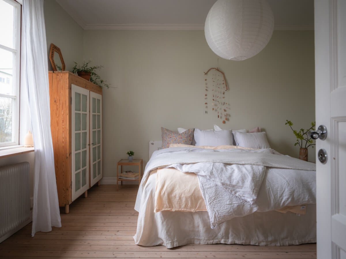 A Soft Color Palette and a Charming Kitchen in a Swedish Apartment 24 light green walls bedroom wooden floor