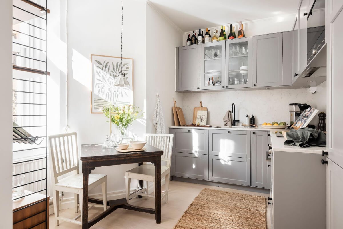 A Bright One-Bedroom Apartment with a Large Balcony 16 light kitchen gray cabinets wooden table