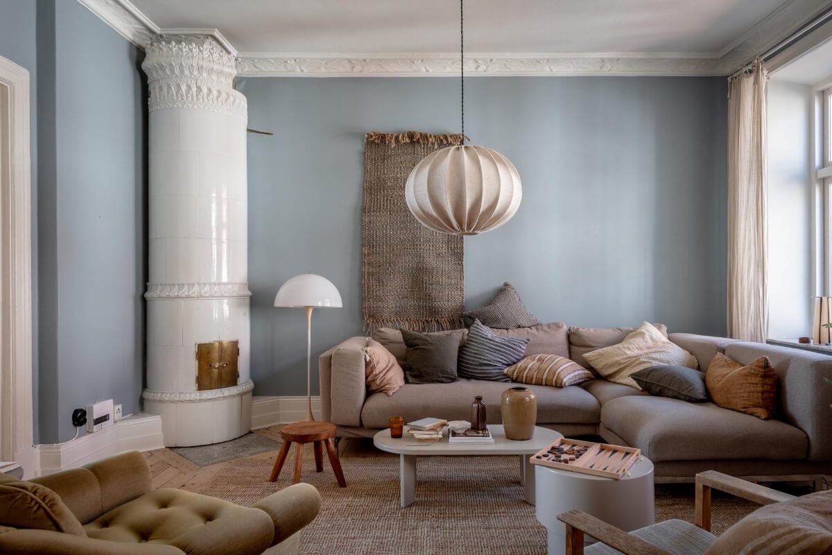 A Natural Color Palette, Period Features, & Grand Rooms in a Swedish Home 2 living room blue walls earthy textiles fireplace