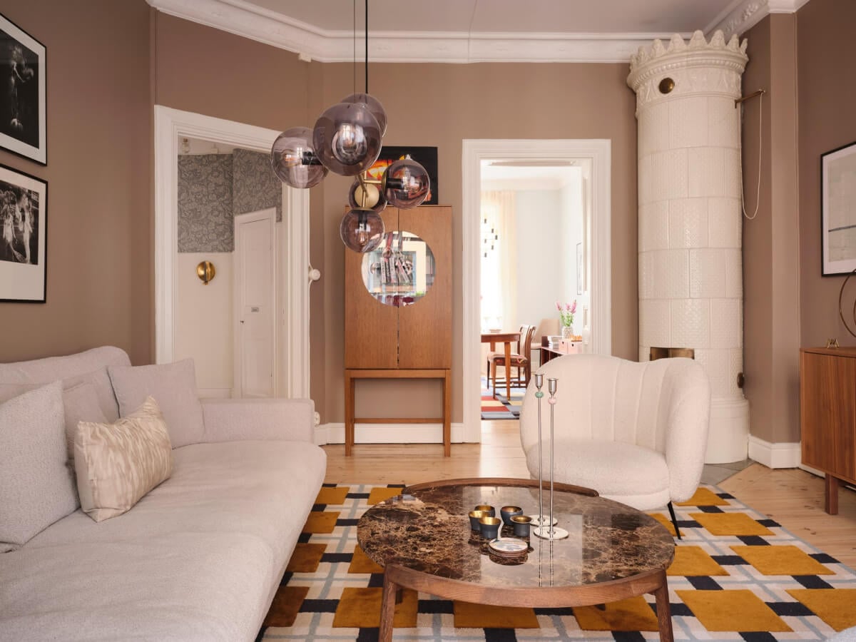 A Spacious Turn-of-the-Century Apartment with Nice Color Accents 1 living room brown walls fireplace