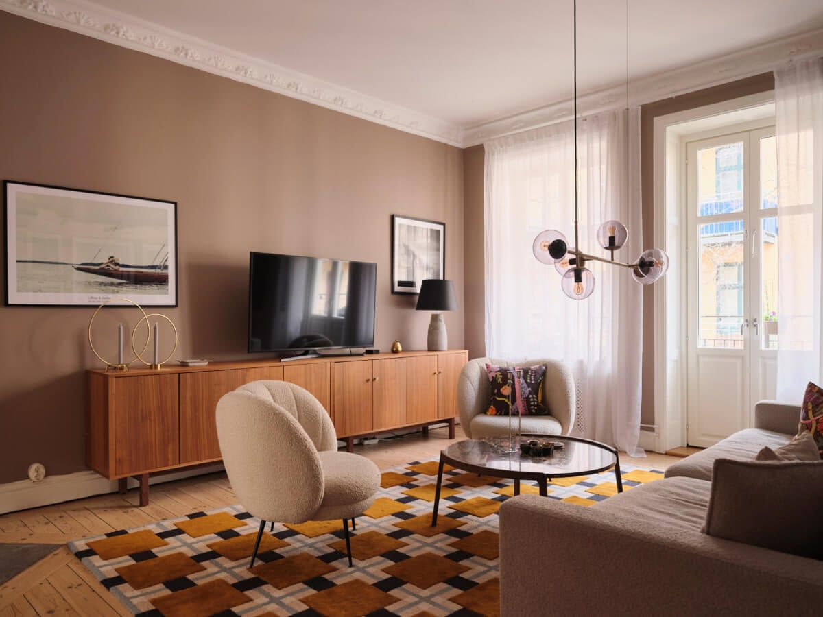 A Spacious Turn-of-the-Century Apartment with Nice Color Accents 2 living room brown walls original stucco