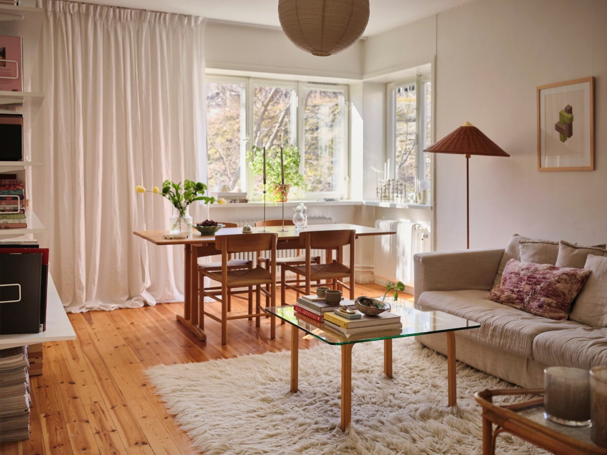 A Light-Filled Functionalist Apartment in Stockholm 2 living room corner window wooden floor