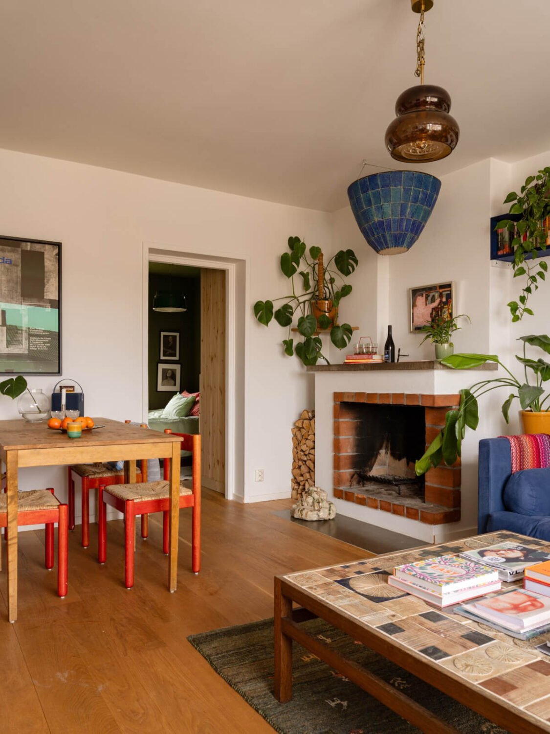 Color Accents in a Renovated Midcentury Apartment in Stockholm 11 living room dining table fireplace