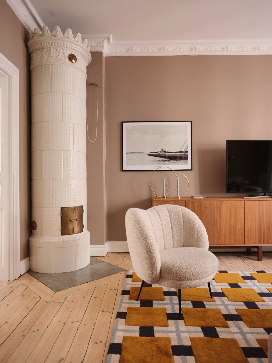 A Spacious Turn-of-the-Century Apartment with Nice Color Accents 5 living room fireplace armchair