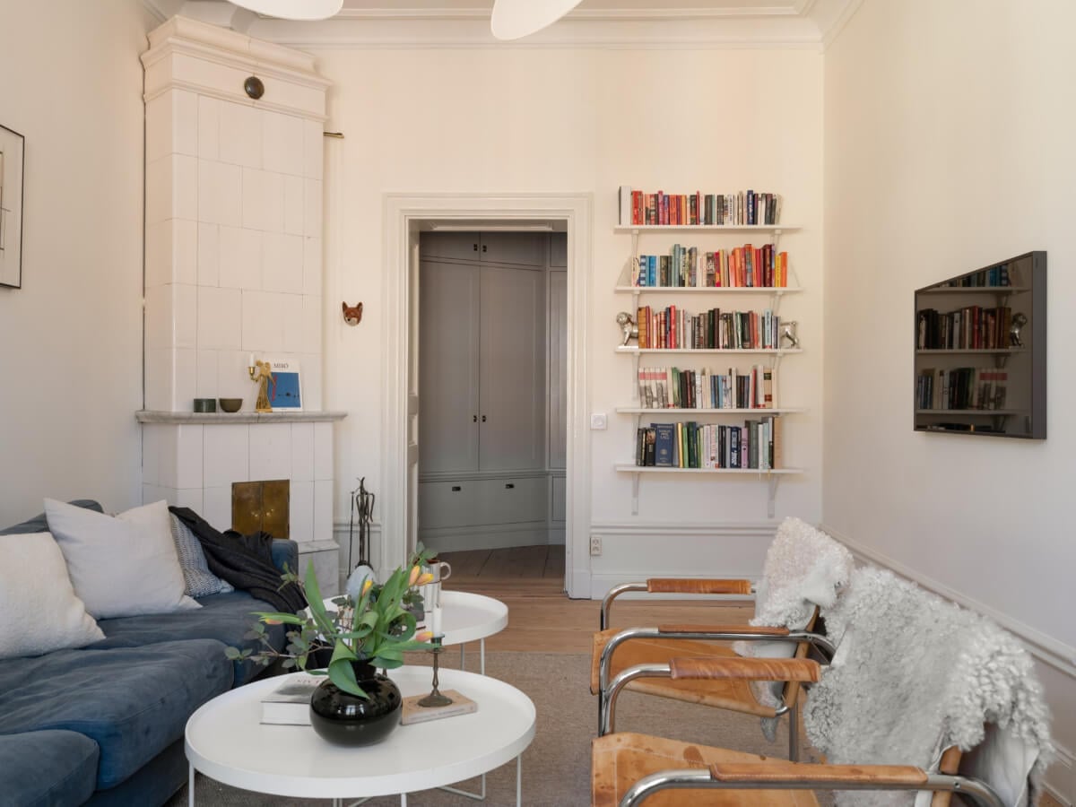 Turn-of-the-Century Charm and Site-Built Storage in a Stockholm Apartment 5 living room fireplace bookshelves
