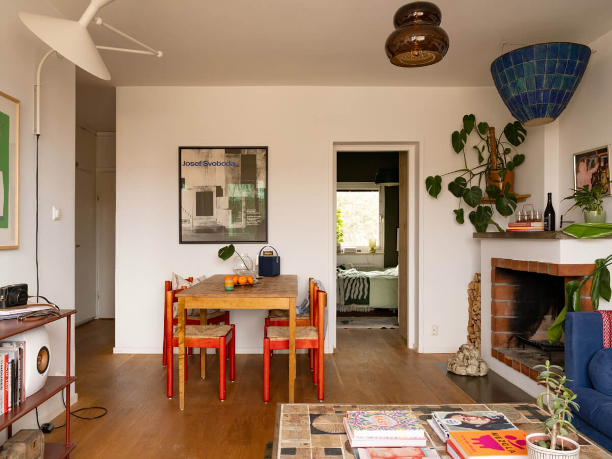 Color Accents in a Renovated Midcentury Apartment in Stockholm 10 living room fireplace dining table
