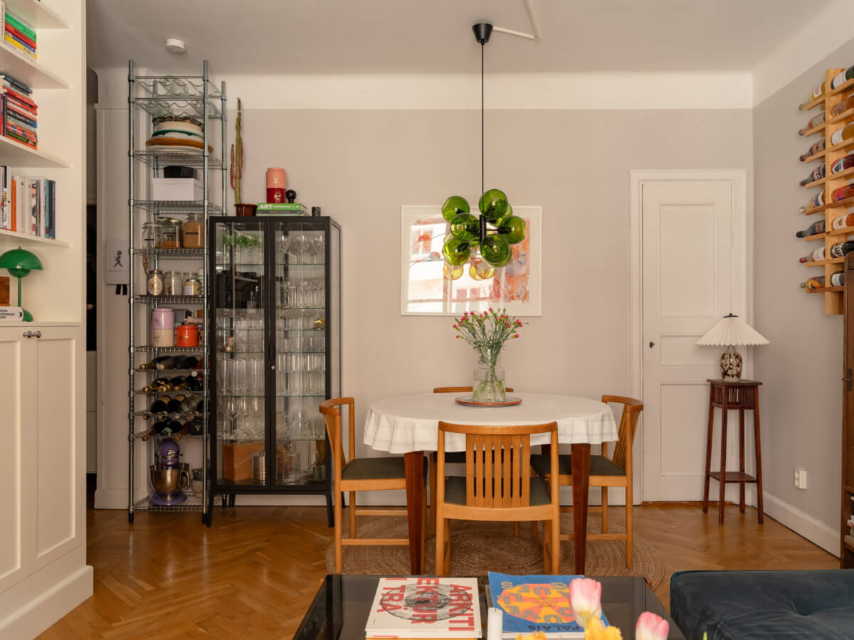 A Small, Cozy Apartment with Built-in Storage and Bookshelves 6 living room light gray walls round dining table