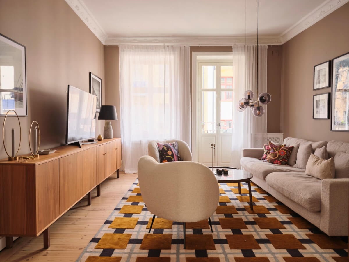 A Spacious Turn-of-the-Century Apartment with Nice Color Accents 3 living room ochre rug brown walls