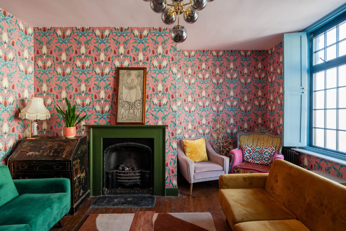 Colorful Design and Historic Features in a Charming English Home 7 living room pink floral wallpaper fireplace nordroom