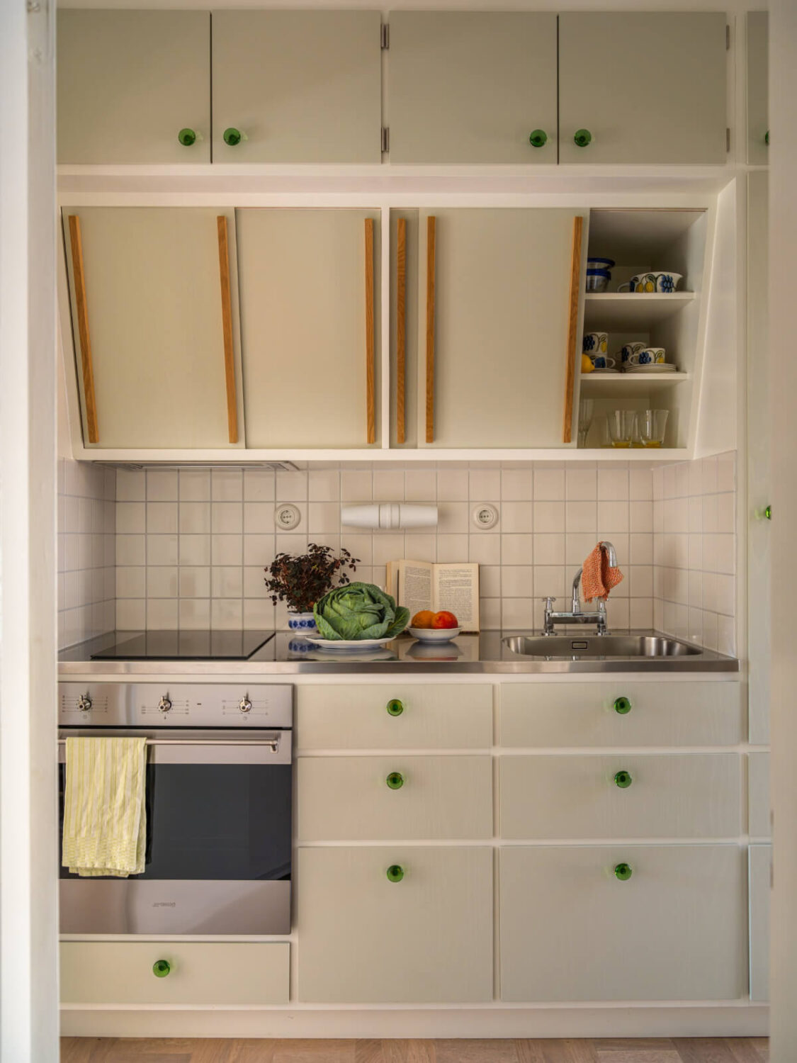 A Tiny Apartment Filled with Books and a Midcentury-Style Kitchen 18 midcentury kitchen angled upper cabinets
