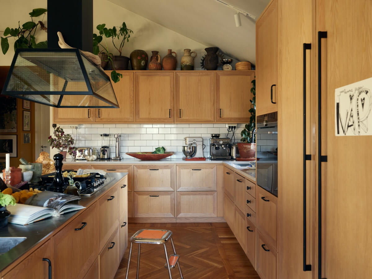 A Personal and Cozy 1960s Family Home in Sweden 6 oak kitchen white backsplash tiles