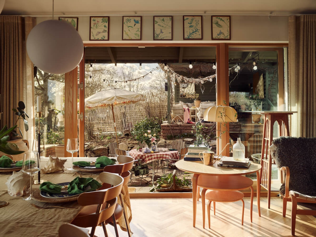 A Personal and Cozy 1960s Family Home in Sweden 2 open plan living space large window garden view