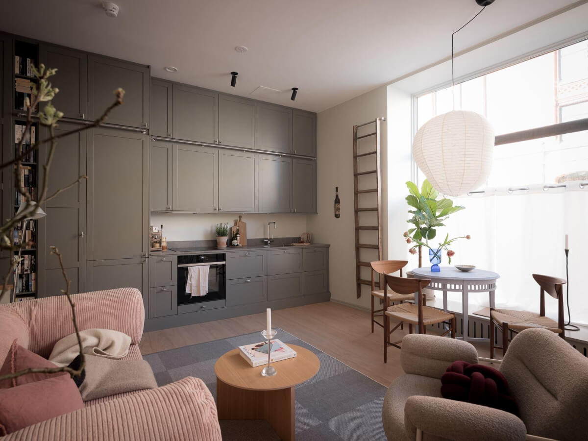 A Modern Split-Level Apartment in a Former Bakery 6 open-plan living space pink sofa large window