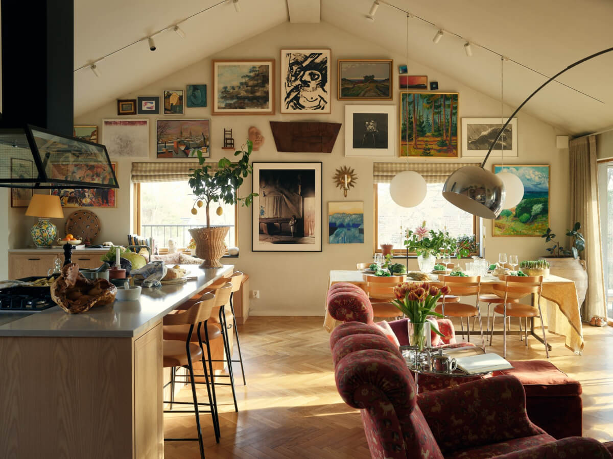 A Personal and Cozy 1960s Family Home in Sweden 1 open plan living space pitched ceiling gallery wall