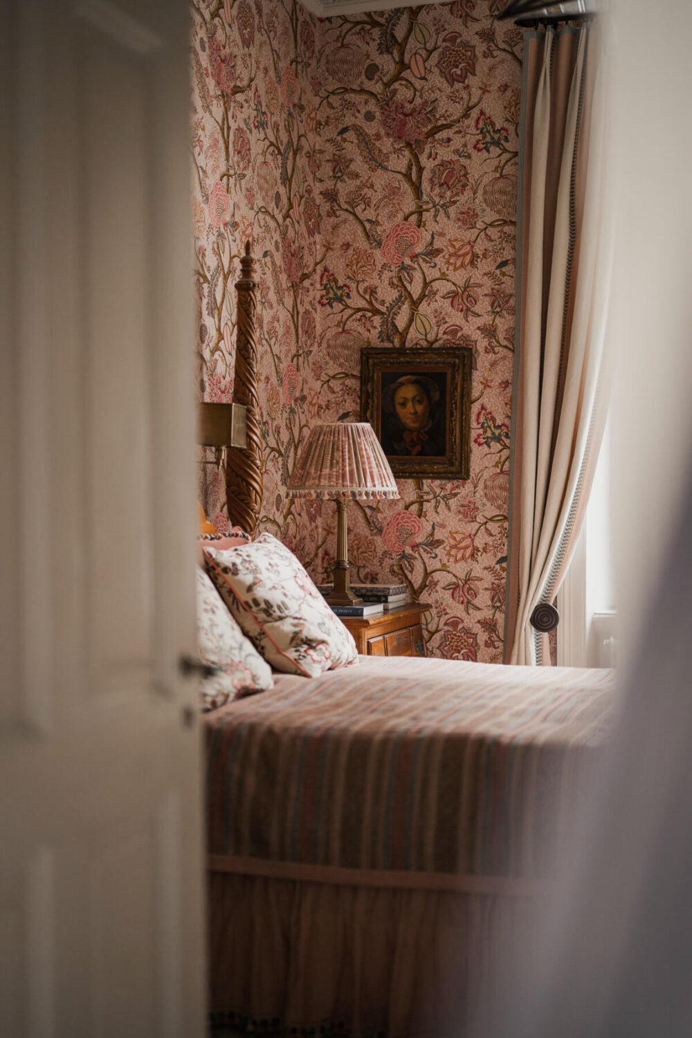 A Spectacular Kitchen and Antiques in a Late 19th-Century Apartment 20 peek into bedroom floral pink wallpaper