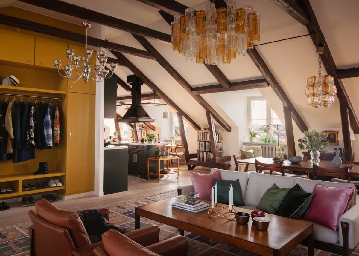 Revisiting a Spectacular Stockholm Penthouse with Exposed Beams 1 penthouse apartment exposed beams yellow hall storage