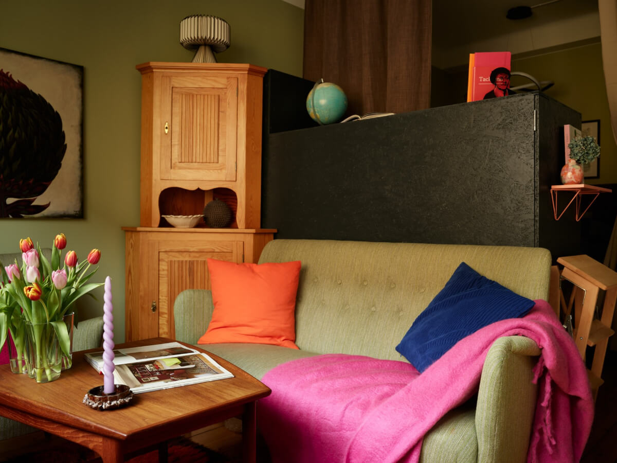 A Colorful Studio Apartment with Smart Storage and A Cozy Bed Niche 6 pink and green studio cabinet room divider