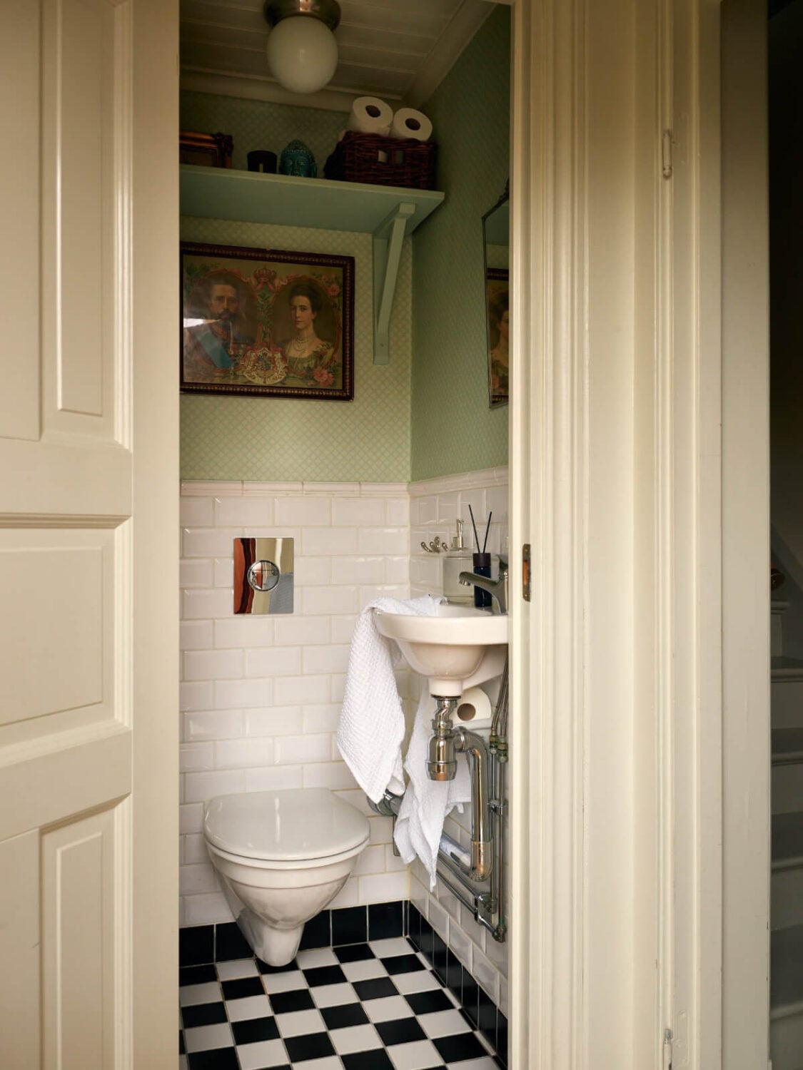 A Charming Semi-Detached House in the First Garden Town of Stockholm 19 powder room green wallpaper shelves checkerboard floor
