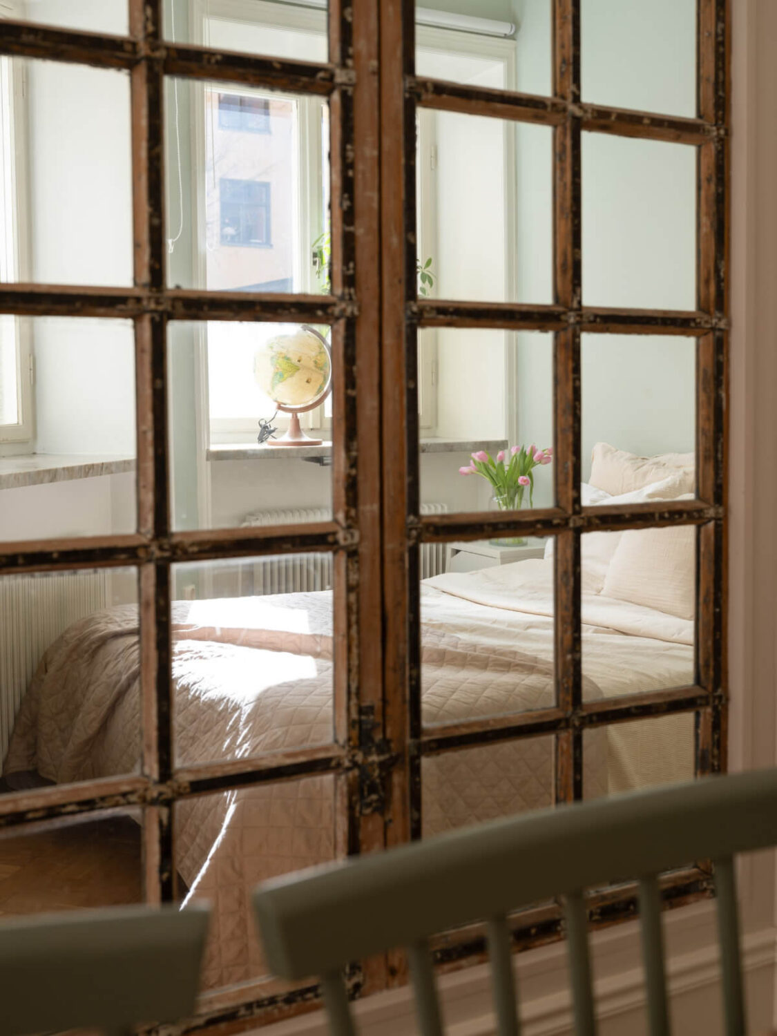 A Small Apartment with Green Color Accents and a Cozy Patio Terrace 3 reclaimed window