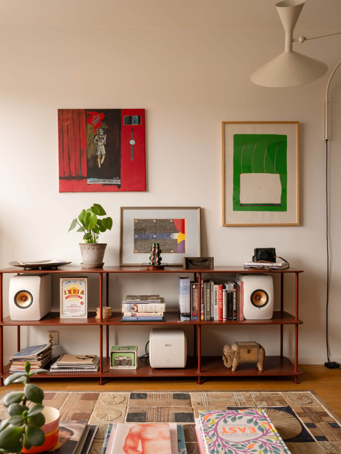 Color Accents in a Renovated Midcentury Apartment in Stockholm 6 red open shelving system