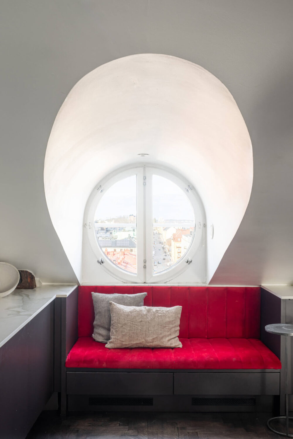 A Stylish Black and White Penthouse Apartment in Stockholm 9 red velvet window seat attic apartment