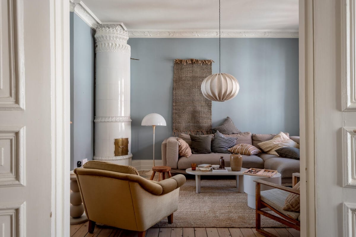 A Natural Color Palette, Period Features, & Grand Rooms in a Swedish Home 5 scandi living room wooden floorboards fireplace