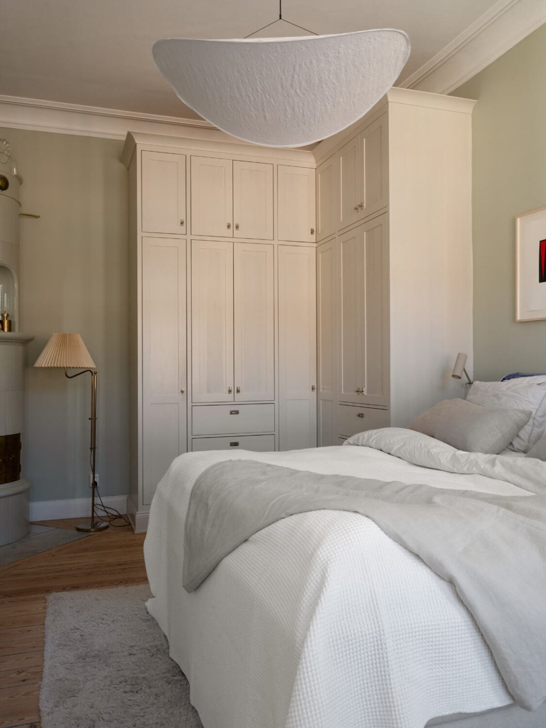 Turn-of-the-Century Charm and Site-Built Storage in a Stockholm Apartment 15 serene bedroom gray-green walls corner built-in wardrobes