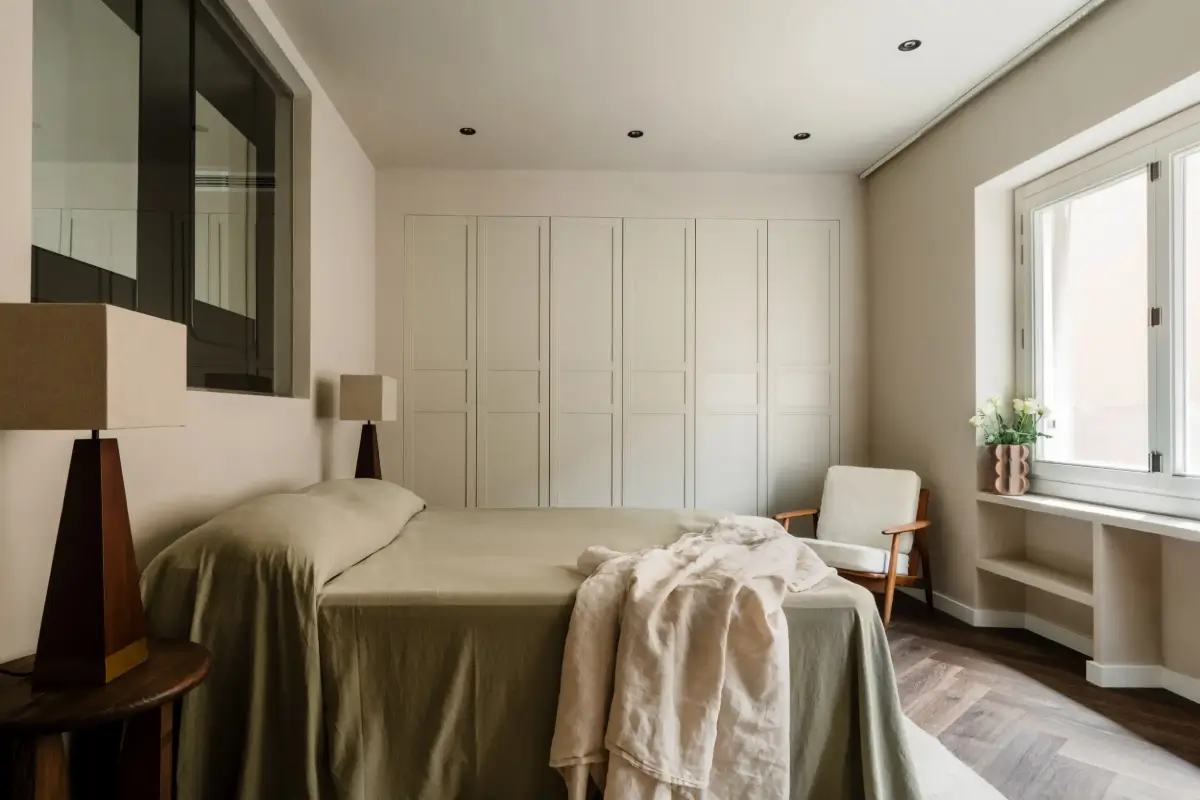 A Luxurious Palma Residence Where Historic Charm Meets Modern Elegance 8 serene bedroom green bedding built in wardrobes