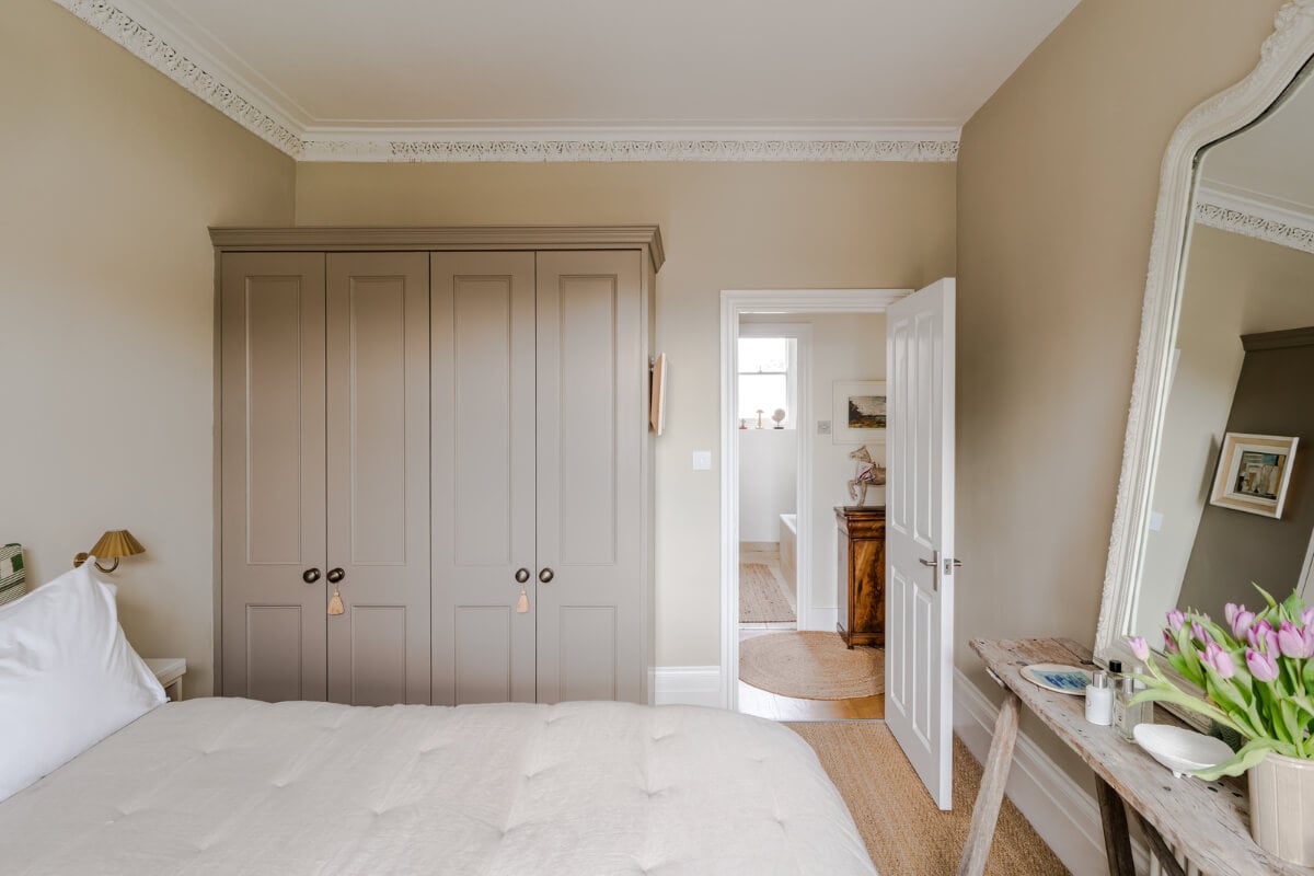 A Serene Color Palette and Arched Windows in a Small English Apartment 11 serene bedroom large mirror wardrobes