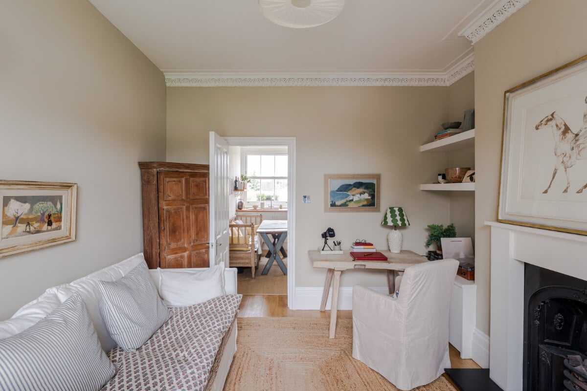A Serene Color Palette and Arched Windows in a Small English Apartment 3 serene living room jute rug desk built-in shelves