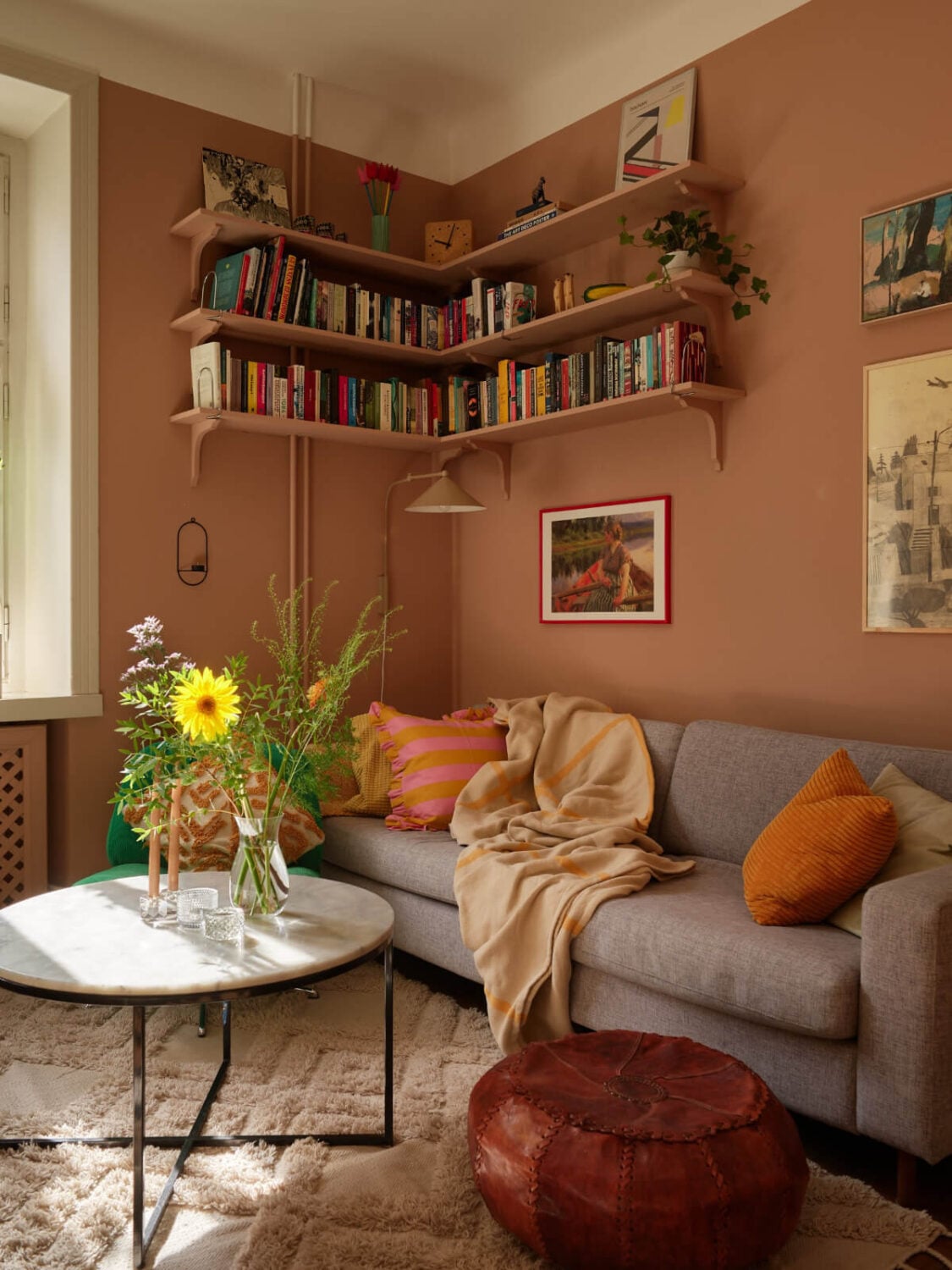 A Nature-Inspired Color Palette in a Stockholm Apartment 4 sitting room dark beige walls corner bookshelves