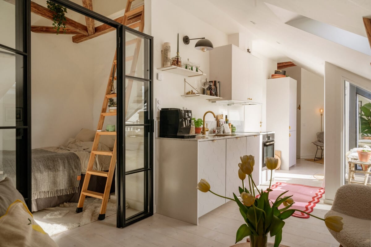 A Bright Attic Apartment with Exposed Beams and a Roof Terrace 5 small attic apartment industrial glass wall