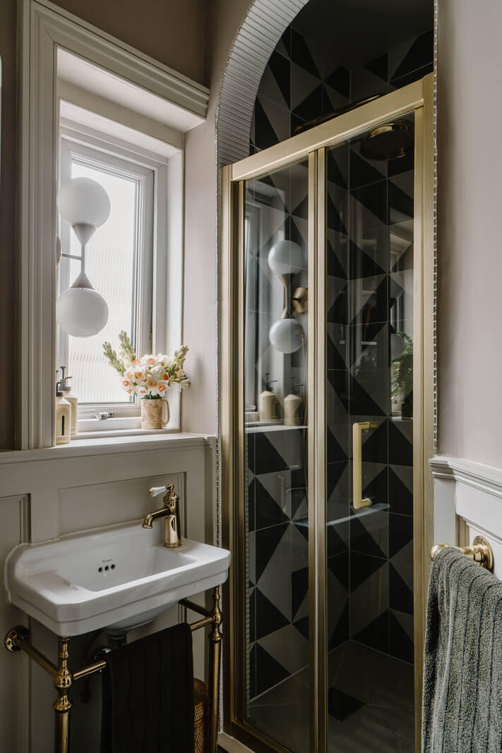 A Classy Apartment on the Top Floors of a 19th-Century Building 13 small bathroom arched shower doorway brass fittings