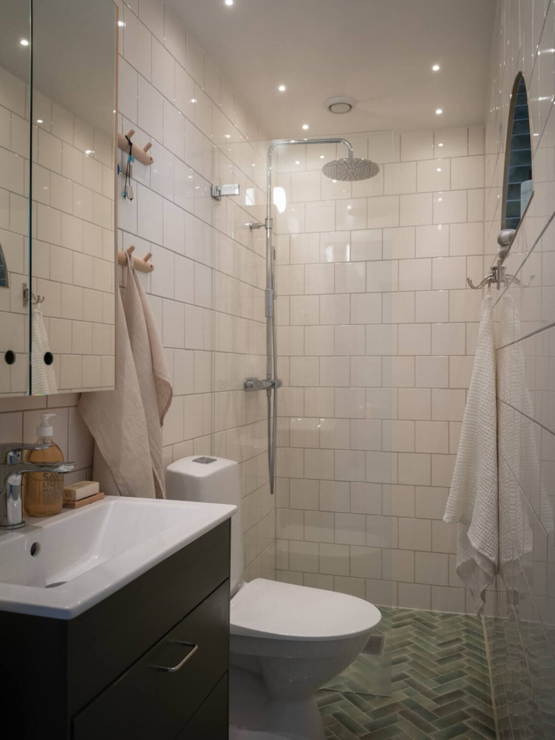 A Soft Color Palette and a Charming Kitchen in a Swedish Apartment 33 small bathroom herringbone floor tiles